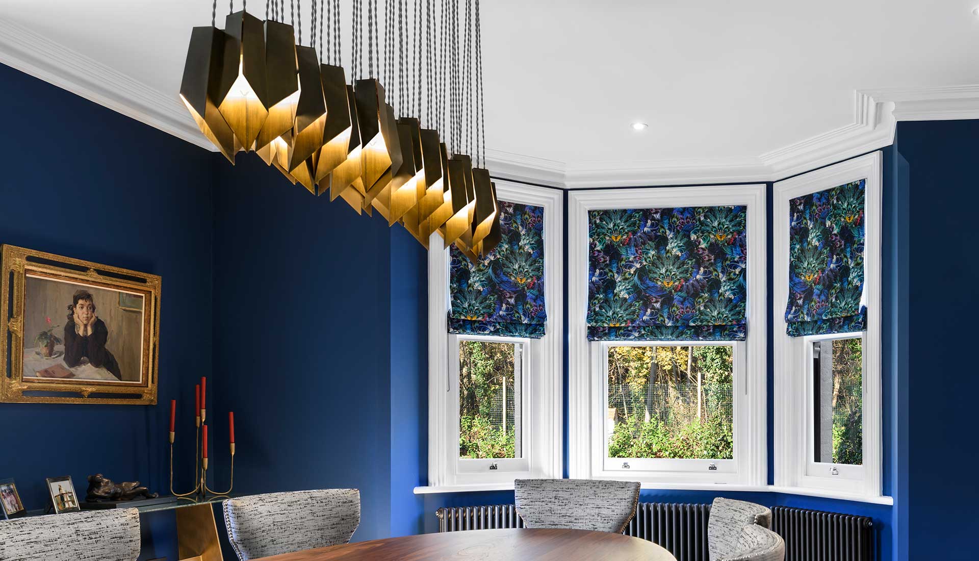 Gold pendant lighting in blue room
