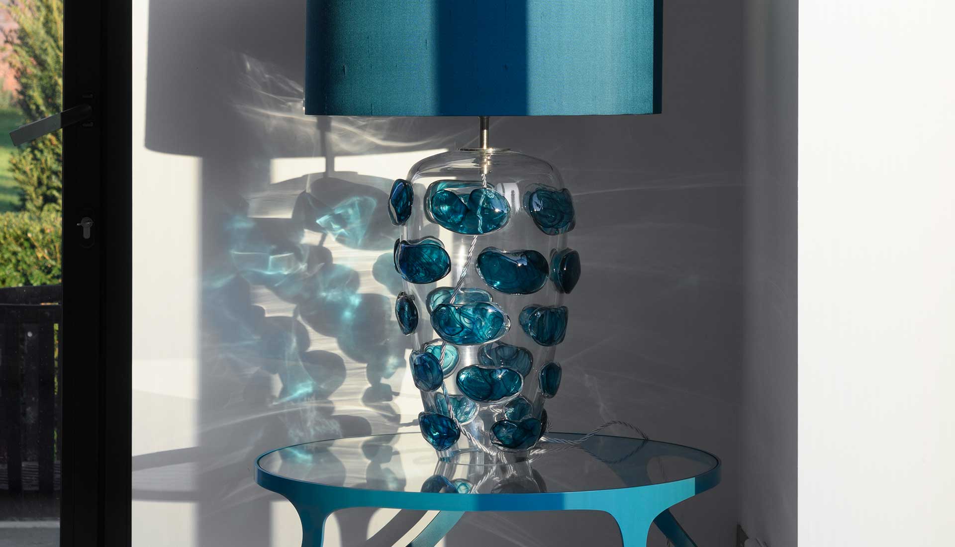 Blue glass lamp on table