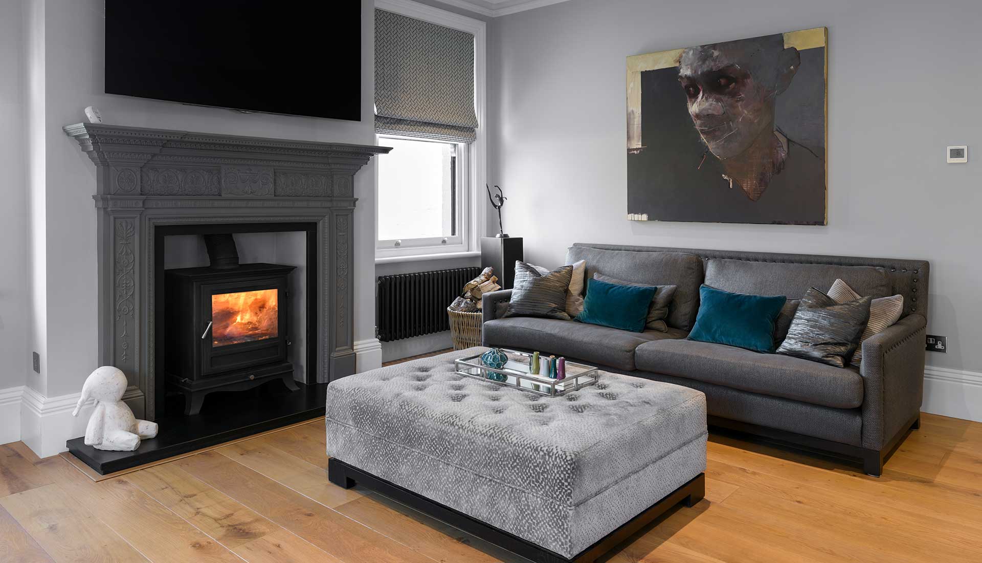 Fireplace with lit fire in grey room