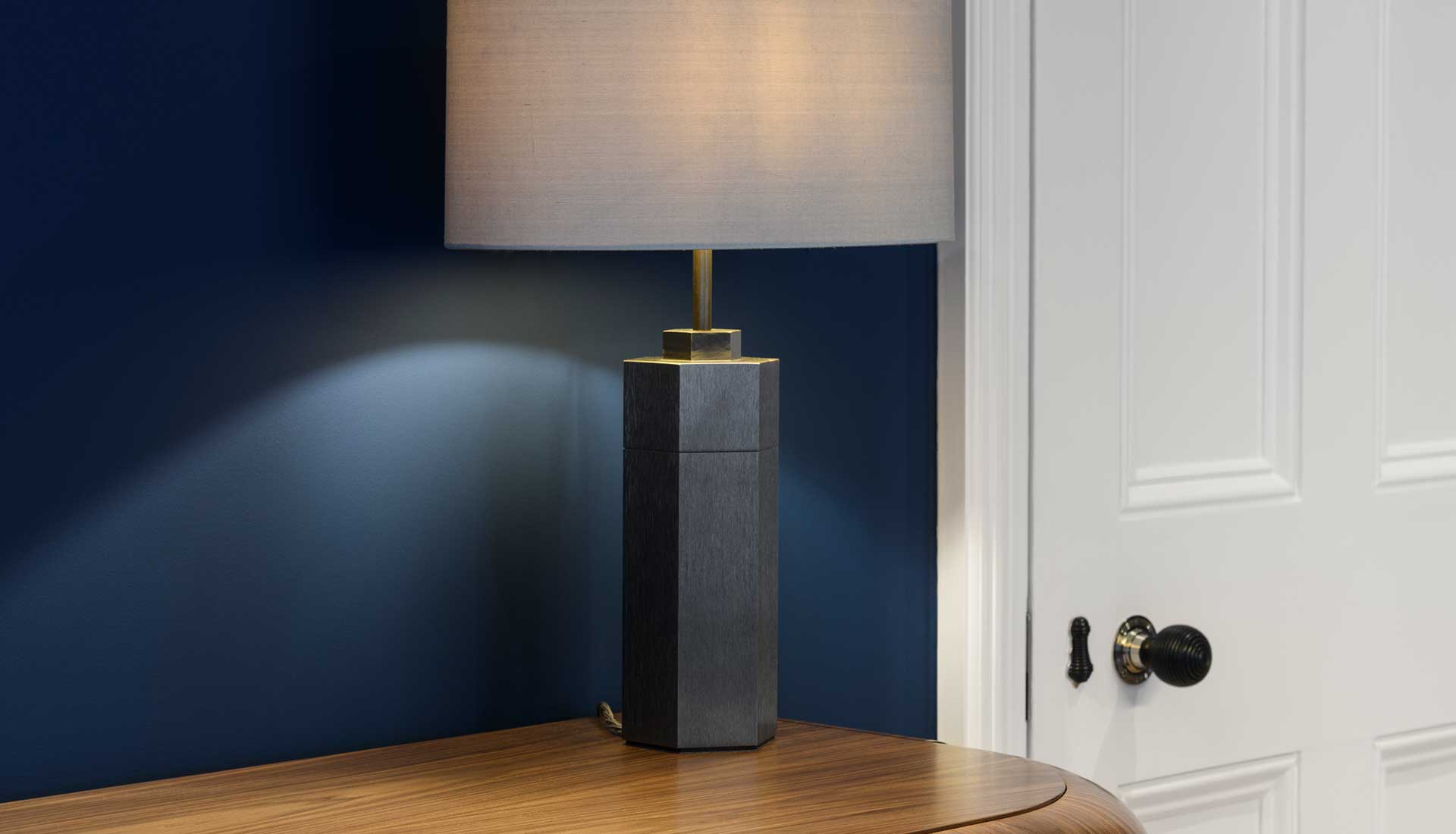 Modern table lamp with blue wall in the background