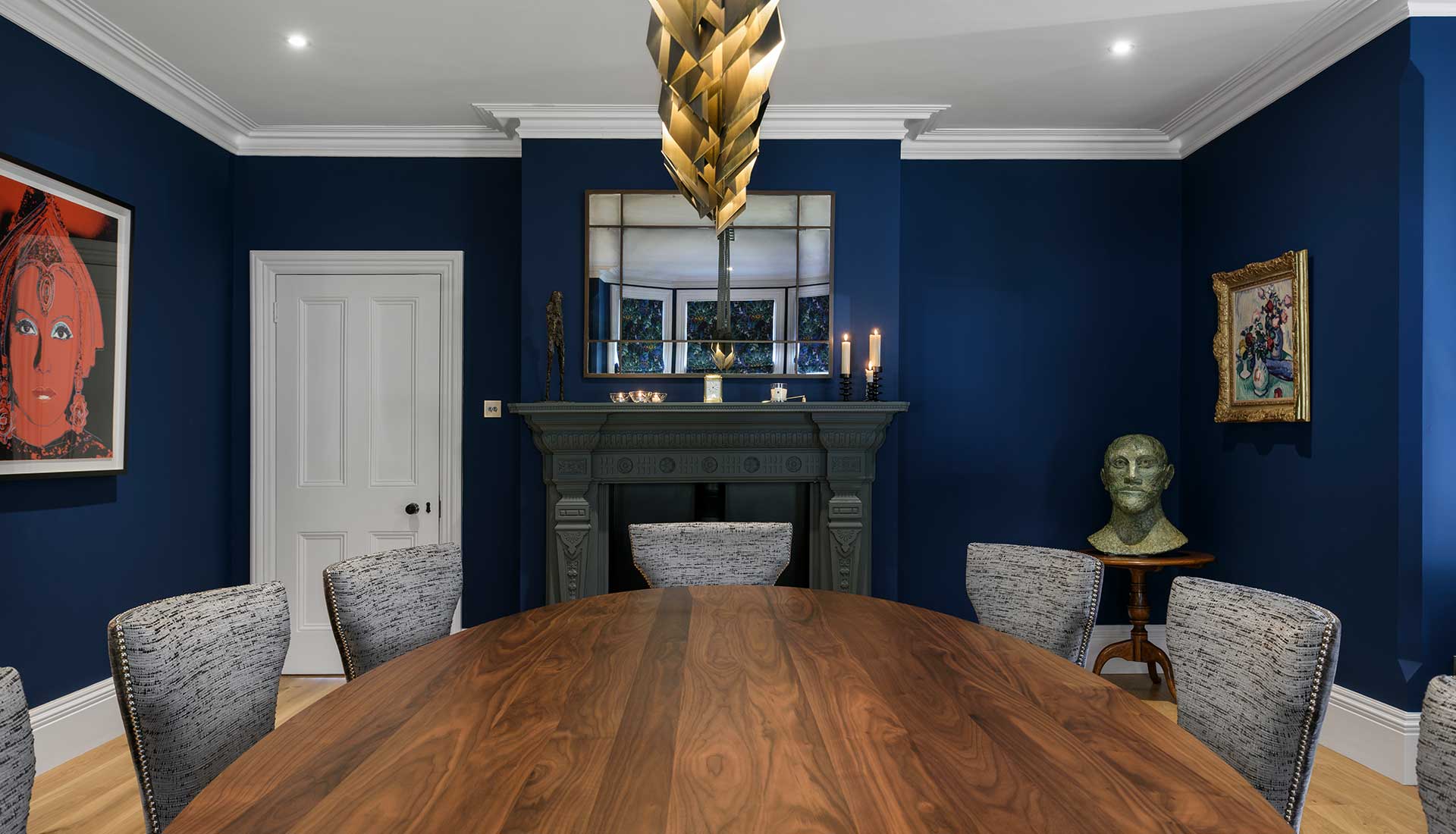 Wooden oval table with chairs surrounding