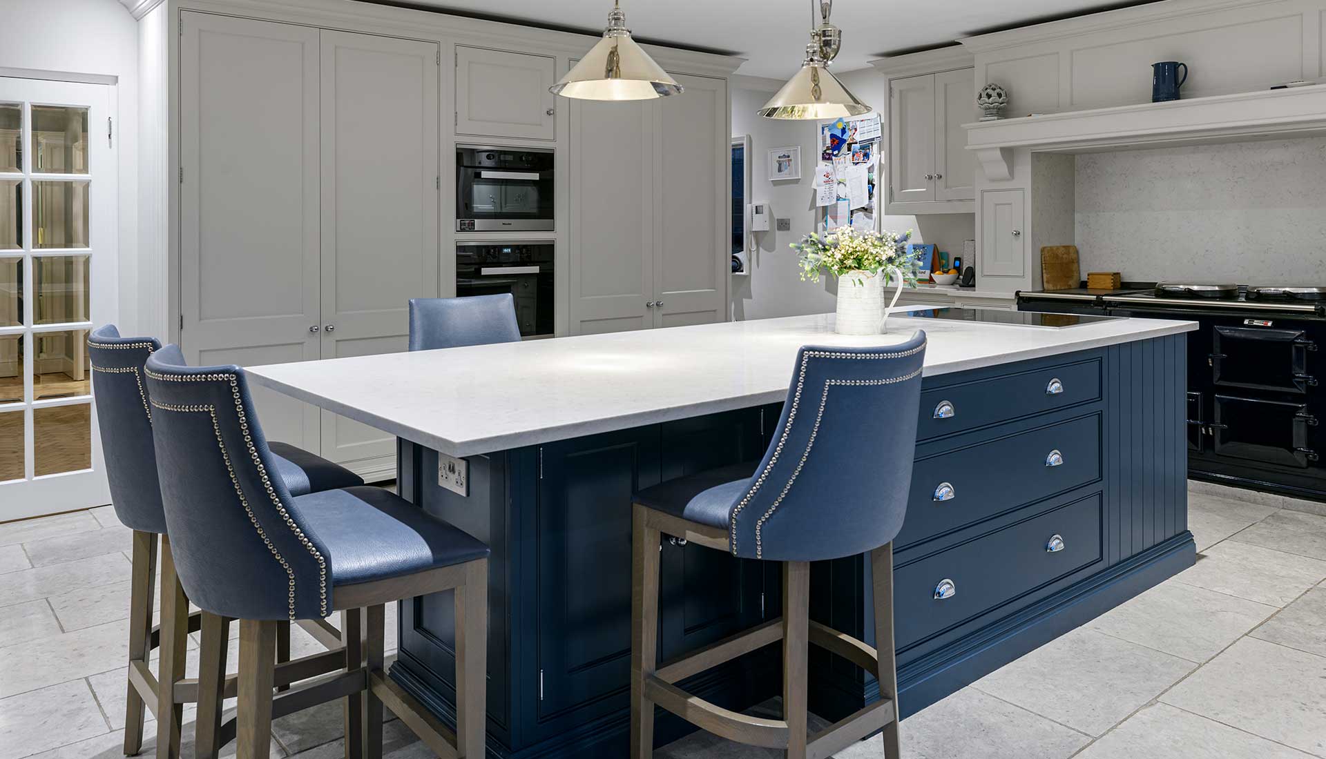 White worktop with blue bar stools in kitchen